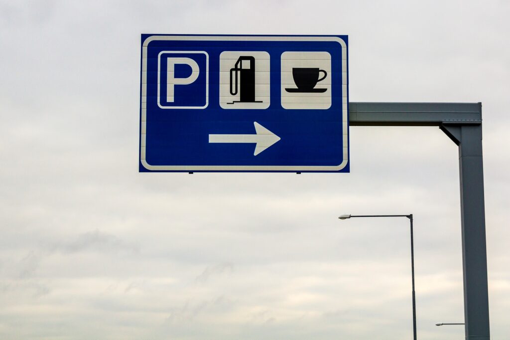 Rest area sign on a pole on freeway road